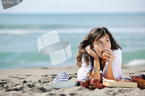 Image of happy young woman on beach