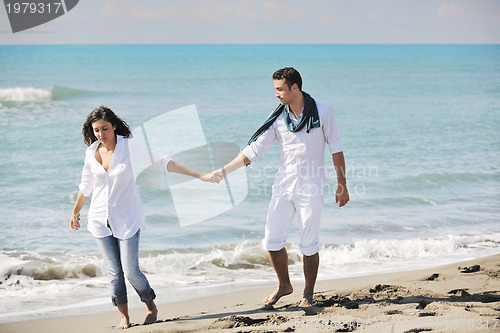Image of happy young couple have fun at beautiful beach