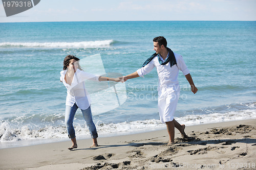 Image of happy young couple have fun at beautiful beach