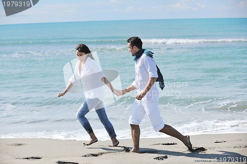 Image of happy young couple have fun at beautiful beach