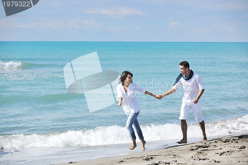 Image of happy young couple have fun at beautiful beach