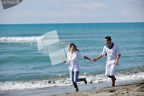 Image of happy young couple have fun at beautiful beach