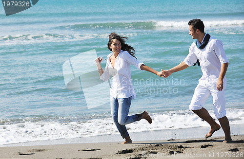 Image of happy young couple have fun at beautiful beach