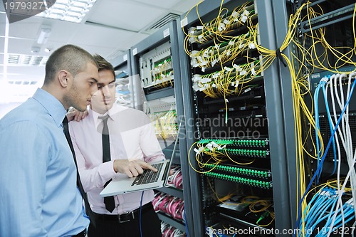 Image of it engineers in network server room