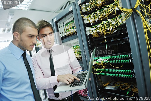 Image of it engineers in network server room