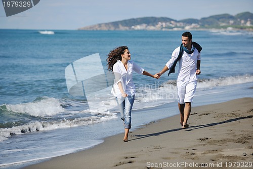 Image of happy young couple have fun at beautiful beach