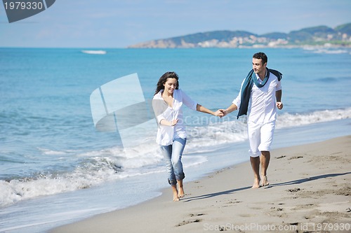 Image of happy young couple have fun at beautiful beach