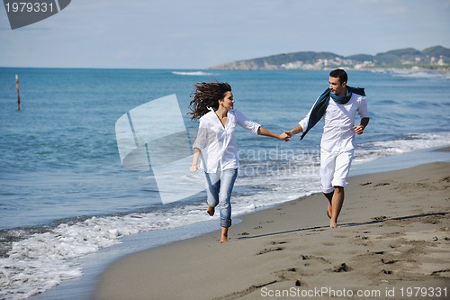 Image of happy young couple have fun at beautiful beach
