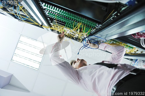 Image of young it engeneer in datacenter server room