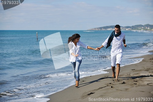 Image of happy young couple have fun at beautiful beach
