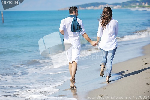 Image of happy young couple have fun at beautiful beach