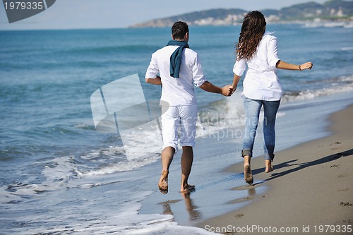 Image of happy young couple have fun at beautiful beach