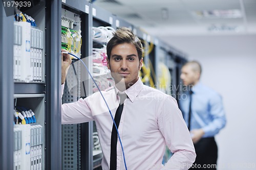 Image of it engineers in network server room