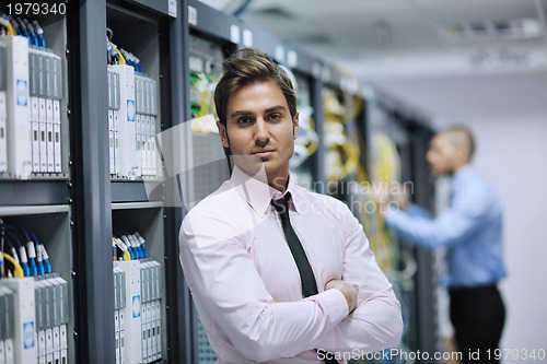 Image of it engineers in network server room