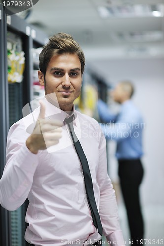 Image of it engineers in network server room