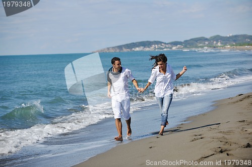 Image of happy young couple have fun at beautiful beach