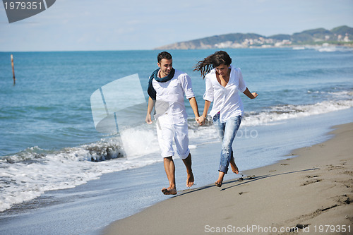 Image of happy young couple have fun at beautiful beach