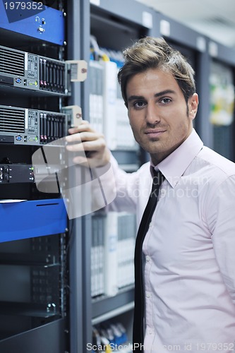 Image of young it engineer in datacenter server room