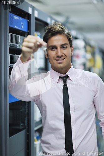 Image of young it engineer in datacenter server room