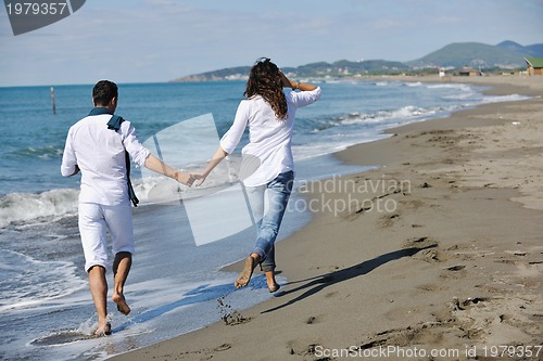 Image of happy young couple have fun at beautiful beach