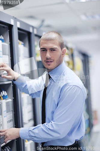 Image of young it engeneer in datacenter server room