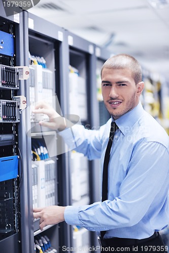 Image of young it engineer in datacenter server room