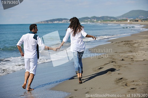 Image of happy young couple have fun at beautiful beach