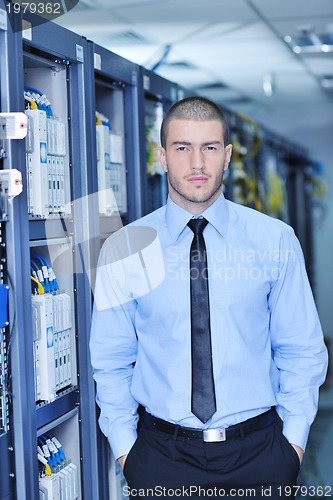 Image of young it engeneer in datacenter server room