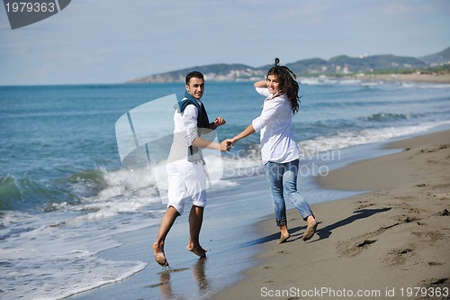 Image of happy young couple have fun at beautiful beach