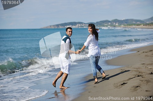 Image of happy young couple have fun at beautiful beach