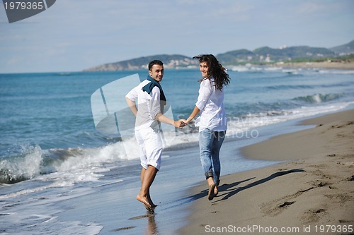 Image of happy young couple have fun at beautiful beach