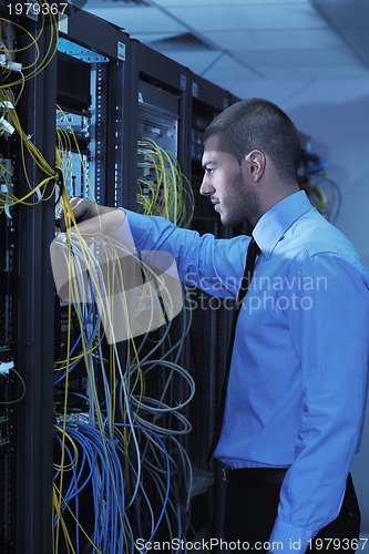 Image of young it engineer in datacenter server room