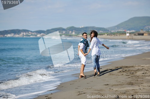 Image of happy young couple have fun at beautiful beach