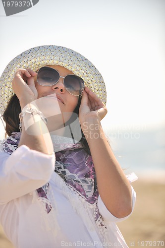 Image of happy young woman on beach