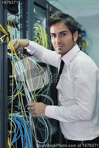 Image of young it engineer in datacenter server room