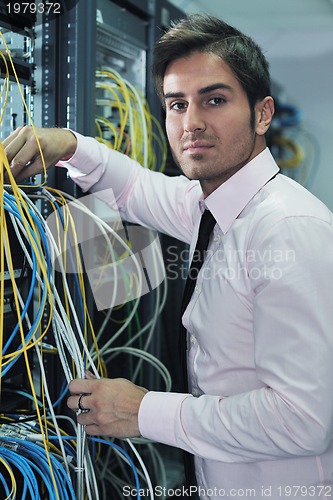 Image of young it engineer in datacenter server room