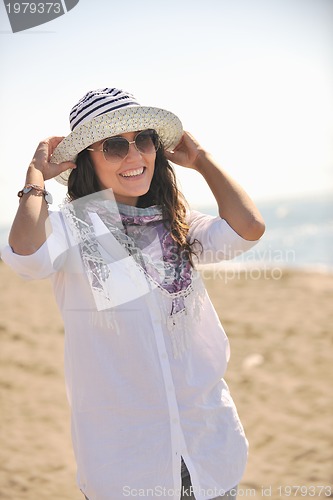 Image of happy young woman on beach
