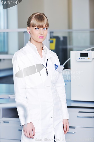 Image of female researcher holding up a test tube in lab