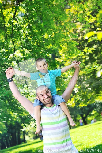 Image of happy father and son have fun at park