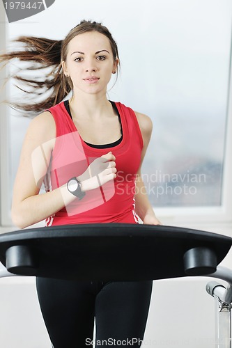 Image of womanworkout  in fitness club on running track machine 