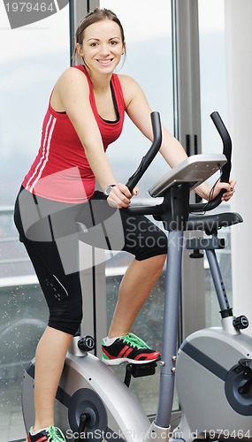 Image of woman workout  in fitness club on running track 