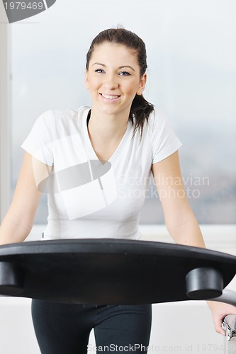 Image of woman workout  in fitness club on running track 