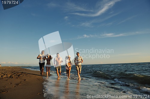Image of people group running on the beach