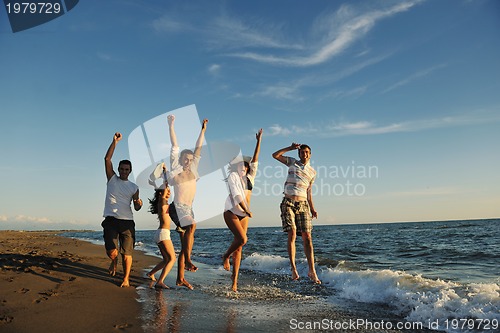 Image of people group running on the beach