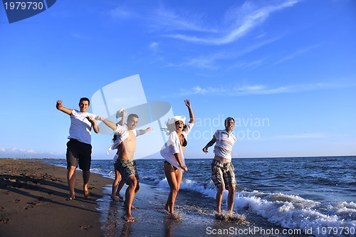 Image of people group running on the beach