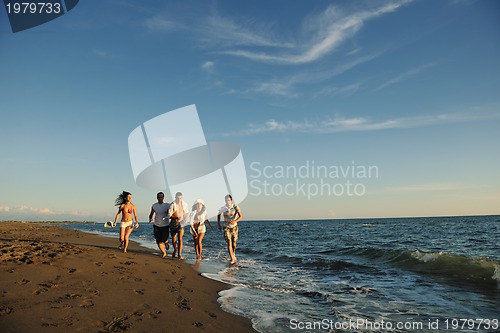 Image of people group running on the beach