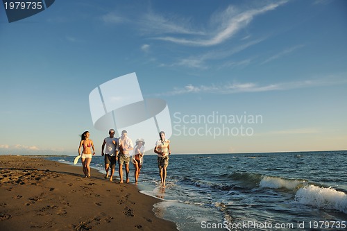 Image of people group running on the beach