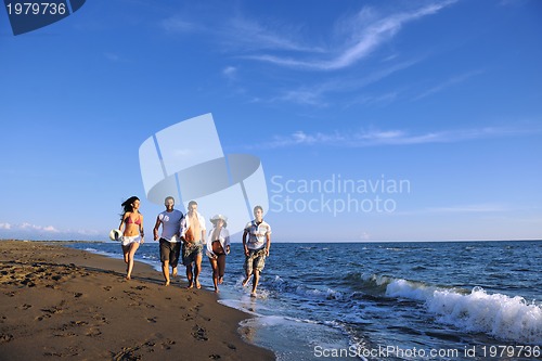 Image of people group running on the beach