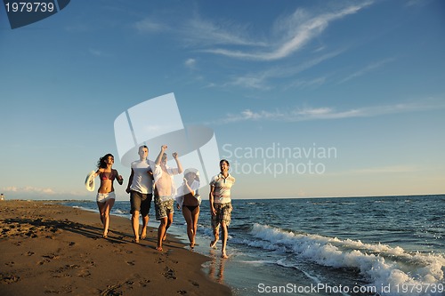 Image of people group running on the beach