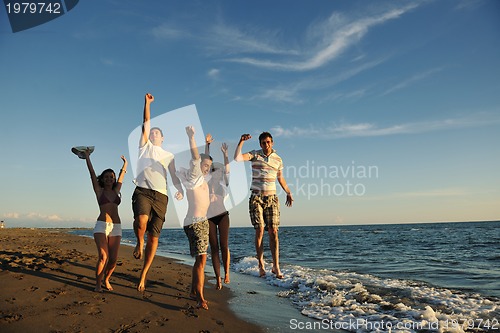 Image of people group running on the beach